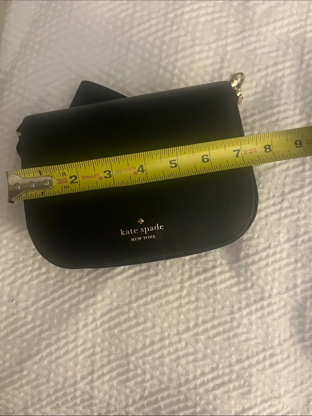 Kate Spade black crossbody saddlebag with gold logo
